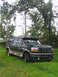 1995 Ford C-350 (Centurion Conversions) - This 1995 Ford C-350 Centurion Conversion SUV is seen parked on a grassy area with trees in the background.