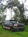 1995 Ford C-350 (Centurion Conversions) - This Ford Bronco Centurion conversion SUV is seen parked in a grassy area with trees overhead.