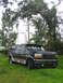 1995 Ford C-350 (Centurion Conversions) - Dark green 1995 Ford C-350 (Centurion Conversions) SUV parked in grassy area.