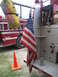 1995 Ford C-350 (Centurion Conversions) - A red fire truck with an American flag and a yellow bag labeled "KEEP PACK" is visible, with another fire truck in the background.