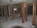 1995 Ford C-350 (Centurion Conversions) - The interior of a building shows exposed studs and concrete flooring, indicating damage or renovation.