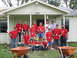 1995 Ford C-350 (Centurion Conversions) - A group of volunteers pose for a photo in front of a house, ready for a day of work.