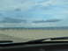 1995 Ford C-350 (Centurion Conversions) - A view of the beach and ocean from inside a vehicle.