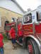 1995 Ford C-350 (Centurion Conversions) - A fire truck with "WAVELAND FIRE DEPT." written on its side is viewed from the side, with two boys standing on its running board.