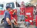 1995 Ford C-350 (Centurion Conversions) - Children interact with a fire truck, which has a license plate indicating "35 95 FIRE CO."