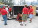 1995 Ford C-350 (Centurion Conversions) - Emergency personnel in red shirts are seen unloading a trailer, with a fire truck visible in the background.