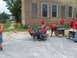 1995 Ford C-350 (Centurion Conversions) - Volunteers move office furniture outside a damaged brick building after a disaster.