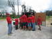 1995 Ford C-350 (Centurion Conversions) - Volunteers in red shirts with 'SEVA' on the back unload supplies from a trailer.