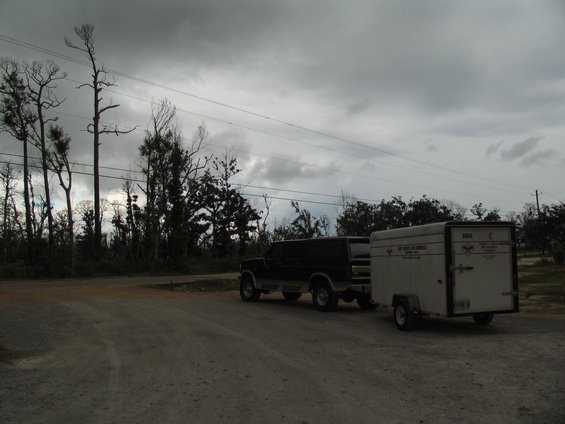Black SUV towing a white trailer with text on it