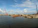 1995 Ford C-350 (Centurion Conversions) - A scene of destruction with cranes overlooking a broken bridge and scattered concrete in the water.