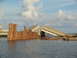 1995 Ford C-350 (Centurion Conversions) - A bridge has collapsed into the water, with debris and pilings visible.