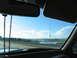 1995 Ford C-350 (Centurion Conversions) - Driving over a bridge with water and marshland visible under a bright blue sky.