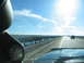 1995 Ford C-350 (Centurion Conversions) - View from inside a vehicle on a highway, with a gauge visible on the dashboard.