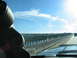 1995 Ford C-350 (Centurion Conversions) - View from a vehicle driving across a bridge, with dashboard gauges visible in the foreground.