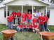1995 Ford C-350 (Centurion Conversions) - Volunteers pose for a photo in front of a house, possibly during a disaster relief effort.