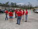 1995 Ford C-350 (Centurion Conversions) - SEMA personnel gather in a lot, with several vehicles visible in the background.