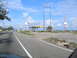 1995 Ford C-350 (Centurion Conversions) - Roadside view of an abandoned Shell gas station, likely damaged by a storm.