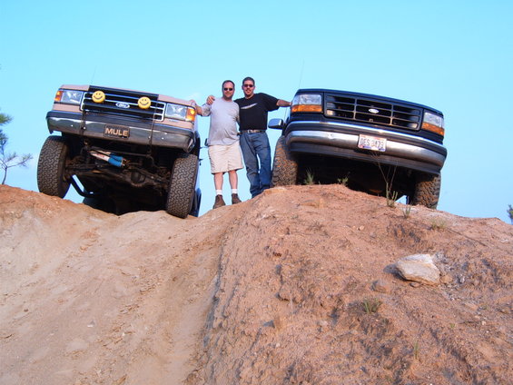 1993 Ford Bronco and another Ford truck on a dirt hill