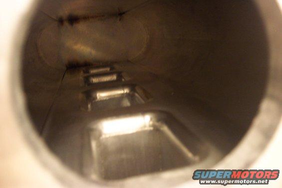 Inside view of a metal pipe with internal bracing or baffles