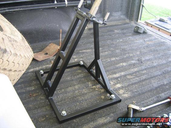 Tire jack in truck bed next to spare tire