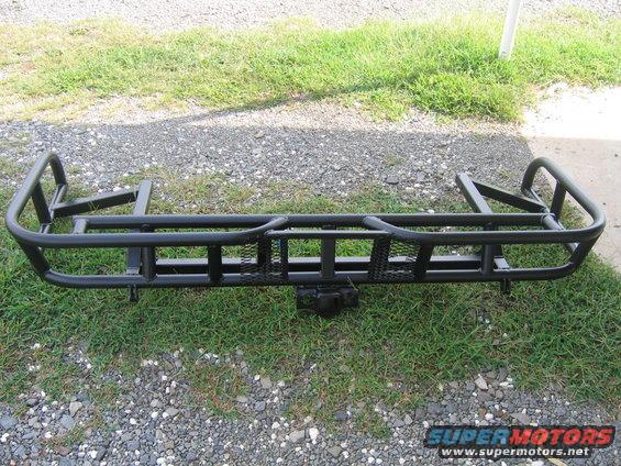 black aftermarket rear bumper with tire carrier and hitch receiver