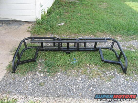 Black metal truck bed rack with side rails and ladder rack section