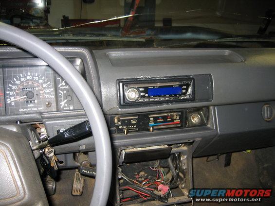 1986 Ford F-150 interior dashboard with cracked windshield and aftermarket radio