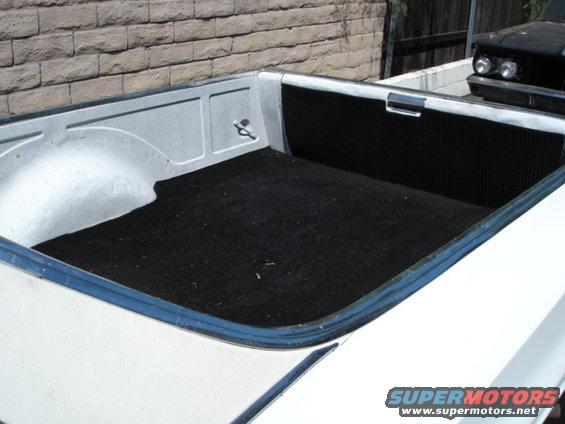 1973 Ford Ranchero bed interior with black matting, another vehicle visible in background