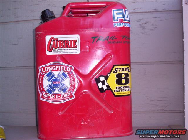 Red jerry can covered in stickers for Currie Enterprises, Longfield Super U-Joint, and Stage 8 Locking Fasteners