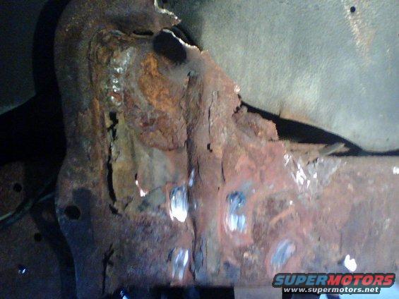 I had to grind off the rivetheads of  what was left of the mount after cutting the shocks off and removing coil.  