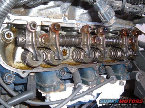 Engine valve train with rocker arms and springs