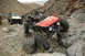 1992 Toyota Tacoma - Two off-road vehicles traverse a challenging rocky trail in a desert landscape.