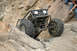 1992 Toyota Tacoma - A custom-built off-road buggy navigates a rocky incline with two people watching from above.