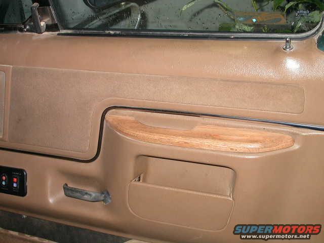 dscn5209.jpg Nice, solid red oak door handle.  The original one was torn off by a passenger in a fit of terror, this one should prove to be more durable.