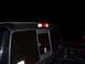 2003 Ford Ranger - Nighttime view of the rear of a black pickup truck, showing tinted windows and stickers.
