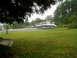 1978 Ford F-250 - Boats are parked on trailers in a grassy area with trees in the background.