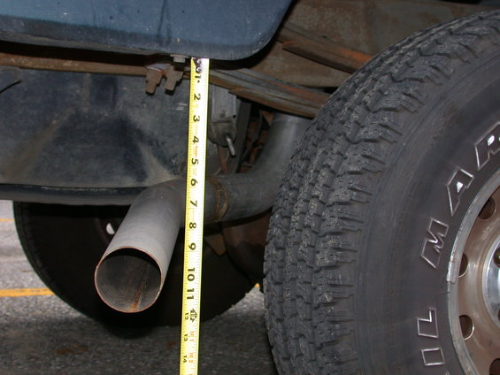 measuring exhaust pipe clearance with a tape measure