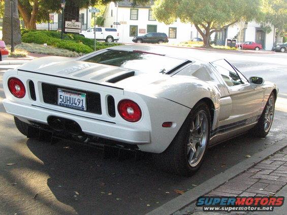 White Ford GT parked on street, rear view. License plate 5UHU491
