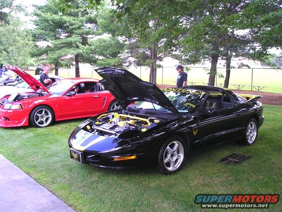 Black 1994 Pontiac Firebird Trans Am with hood open, yellow accents