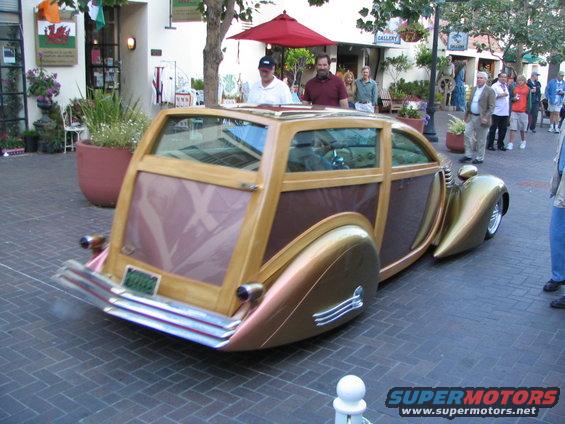 Custom woody wagon with wood paneling and gold accents. License plate visible
