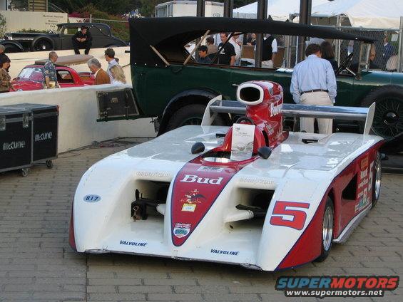 White and red racing car with number 5, Budweiser sponsorship, and air intake