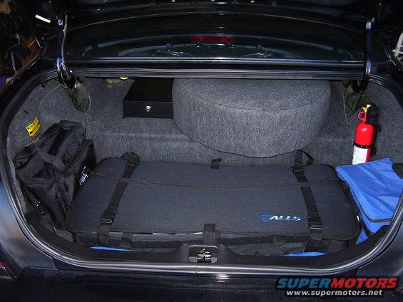 2002 Ford Crown Victoria trunk interior with spare tire, fire extinguisher, and luggage