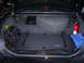 2002 Ford Crown Victoria - The trunk of a 2002 Ford Crown Victoria contains a spare tire, fire extinguisher, and various bags and luggage.
