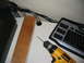 1986 Ford Bronco - A drill and keyboard are on a desk, with cables in the background.