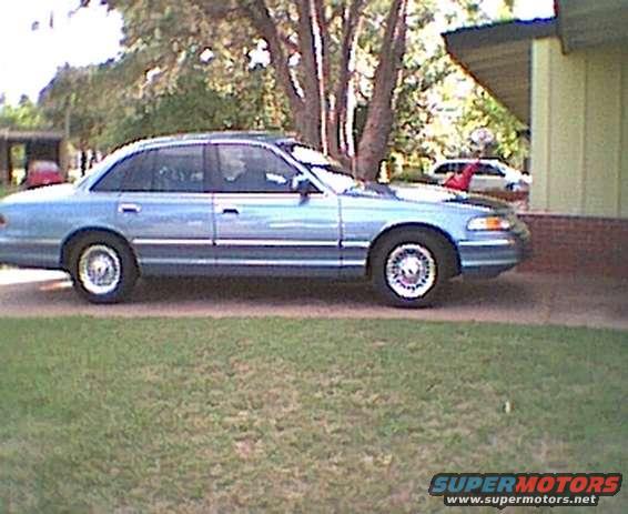 1994 Ford Crown Victoria sedan parked on grass, side view