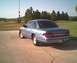 1994 Ford Crown Victoria - Rear view of a blue sedan with a visible license plate and a watermark at the bottom right.