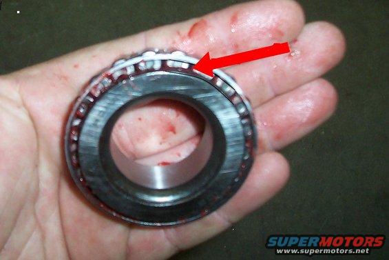 Wheel bearing with red arrow pointing to rollers