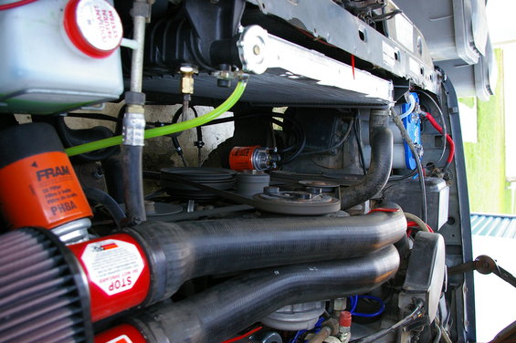Engine compartment with Fram oil filter and red air filter