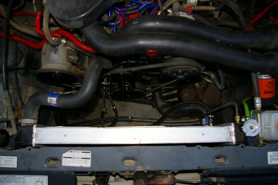 Engine compartment with radiator, hoses, and belts visible
