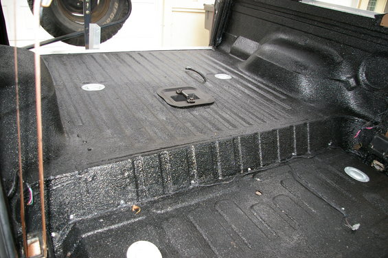 Herculiner-coated interior of a vehicle with a spare tire visible